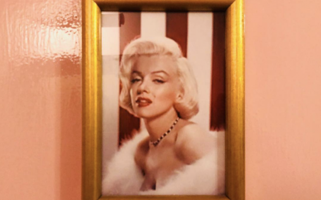 Framed picture of Marilyn Monroe on the bathroom door…Sad, beautiful and strange…
