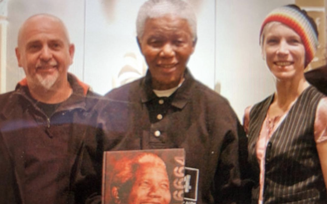 Proudly wearing my rainbow hat, standing ( in awe) next to the late Nelson Mandela
